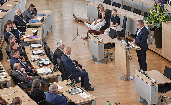 Landtagspräsident Dr. Gunnar Schellenberger während seiner Rede bei der Feierstunde zu „30 Jahre Landesverfassung“ am Rednerpult im Plenarsaal, zudem Blick in den vollbesetzten Plenarsaal.