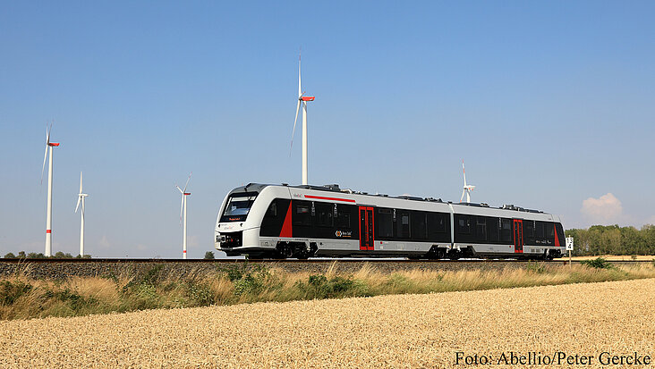 Eine Regionalbahn fährt an einem Feld entlang