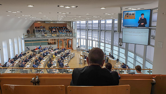 Blick von der Pressetribüne in den Plenarsaal und auf die neuen Großbildschirme an der Seitenwand.